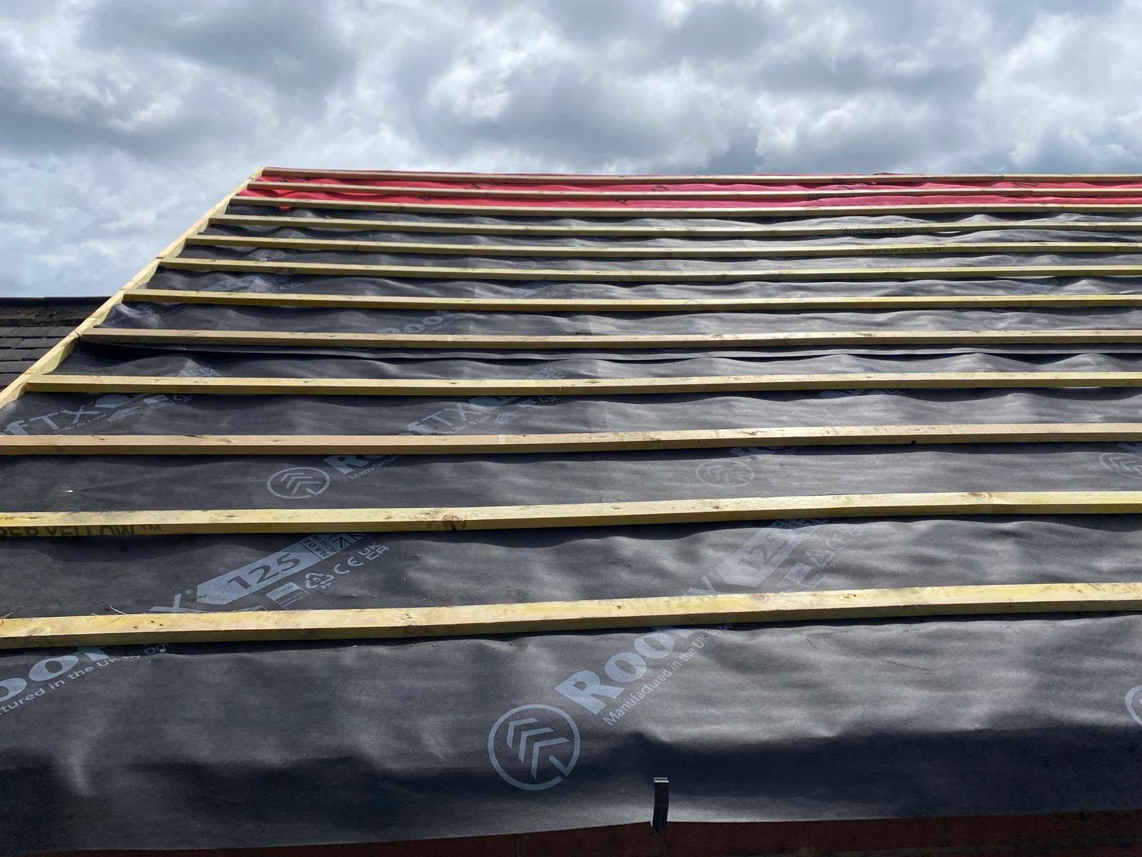 Felt and battens with new red ridge